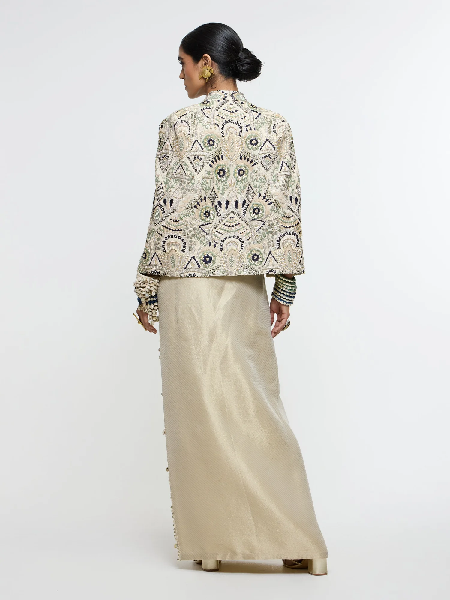 Inayat Embellished Cape Jacket Paired With Metallic Scallop Bustier And Ivory Slit Skirt. by SVA, ivory jacket set, view 3