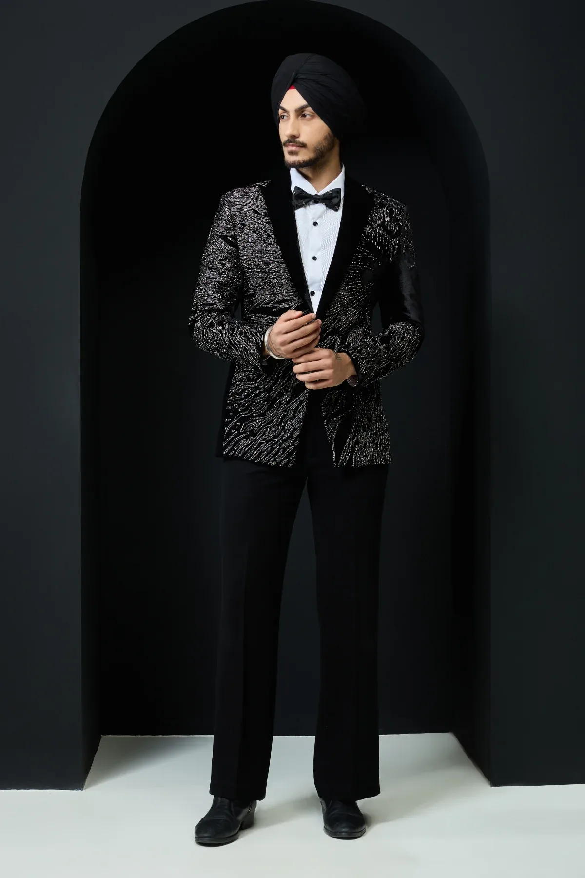 Black tuxedo highlighted with silver zari and peals by Sarab Khanijou