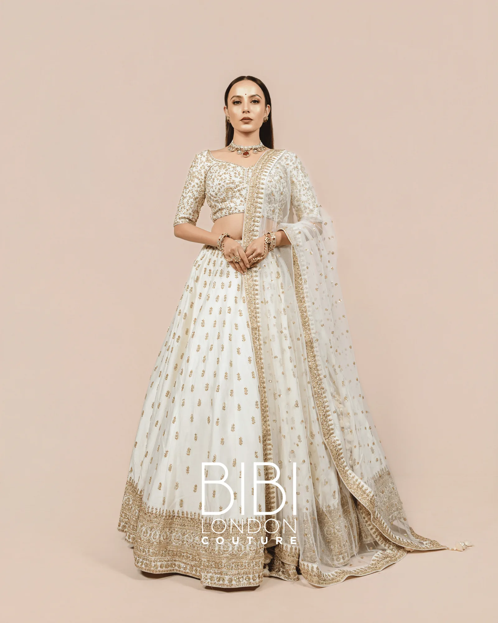 Ivory Lehenga with Gold Sequin Bootis and Embroidered Borders by BIBI London Couture