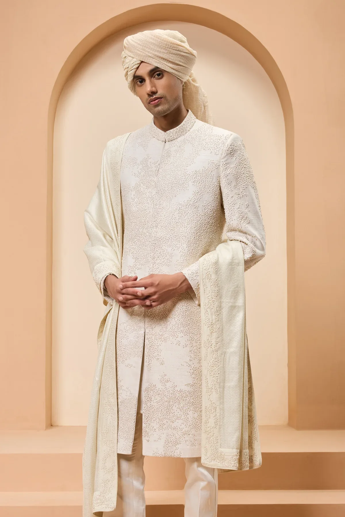 Ivory sherwani detailing with pearl cutdana and thread work by Sarab Khanijou