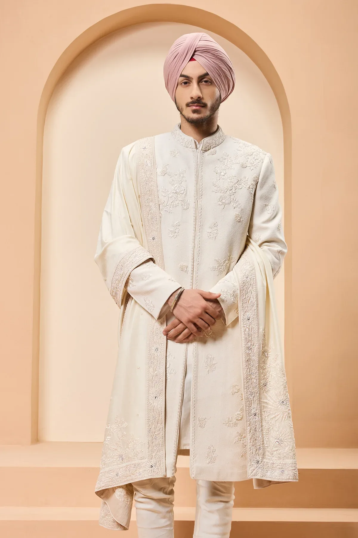 Ivory sherwani detailing with sequins and with thread work by Sarab Khanijou