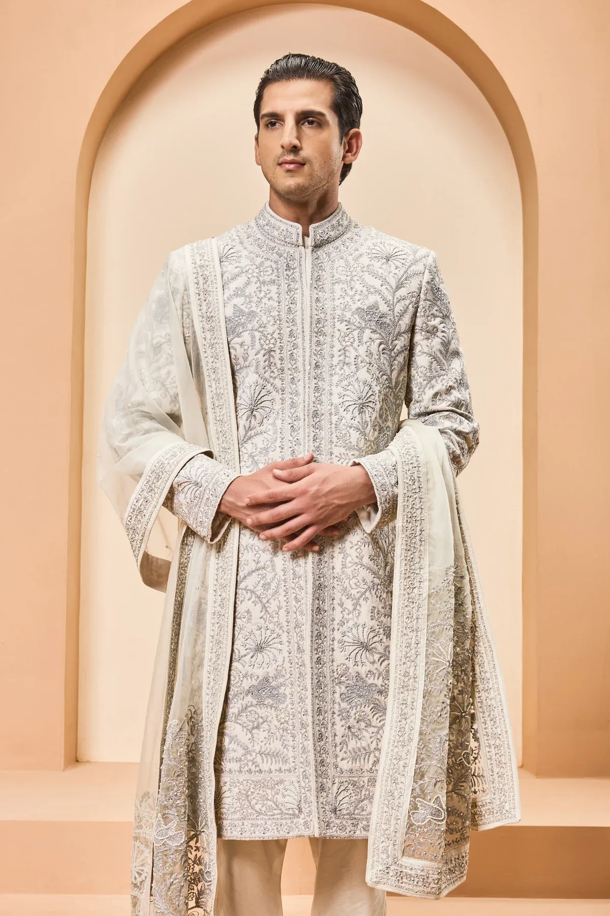 Ivory sherwani detailing with silver zari pearl sequins and thread work by Sarab Khanijou