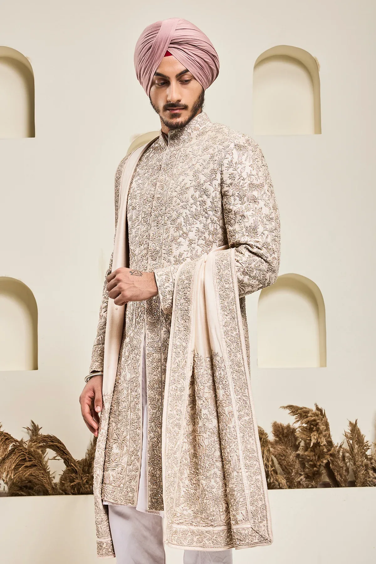 Dusty rose sherwani with pearl sequins and zari work by Sarab Khanijou