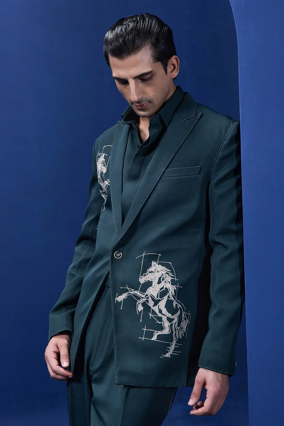 Green blazer detailing with thread work and horse embroidery by Sarab Khanijou