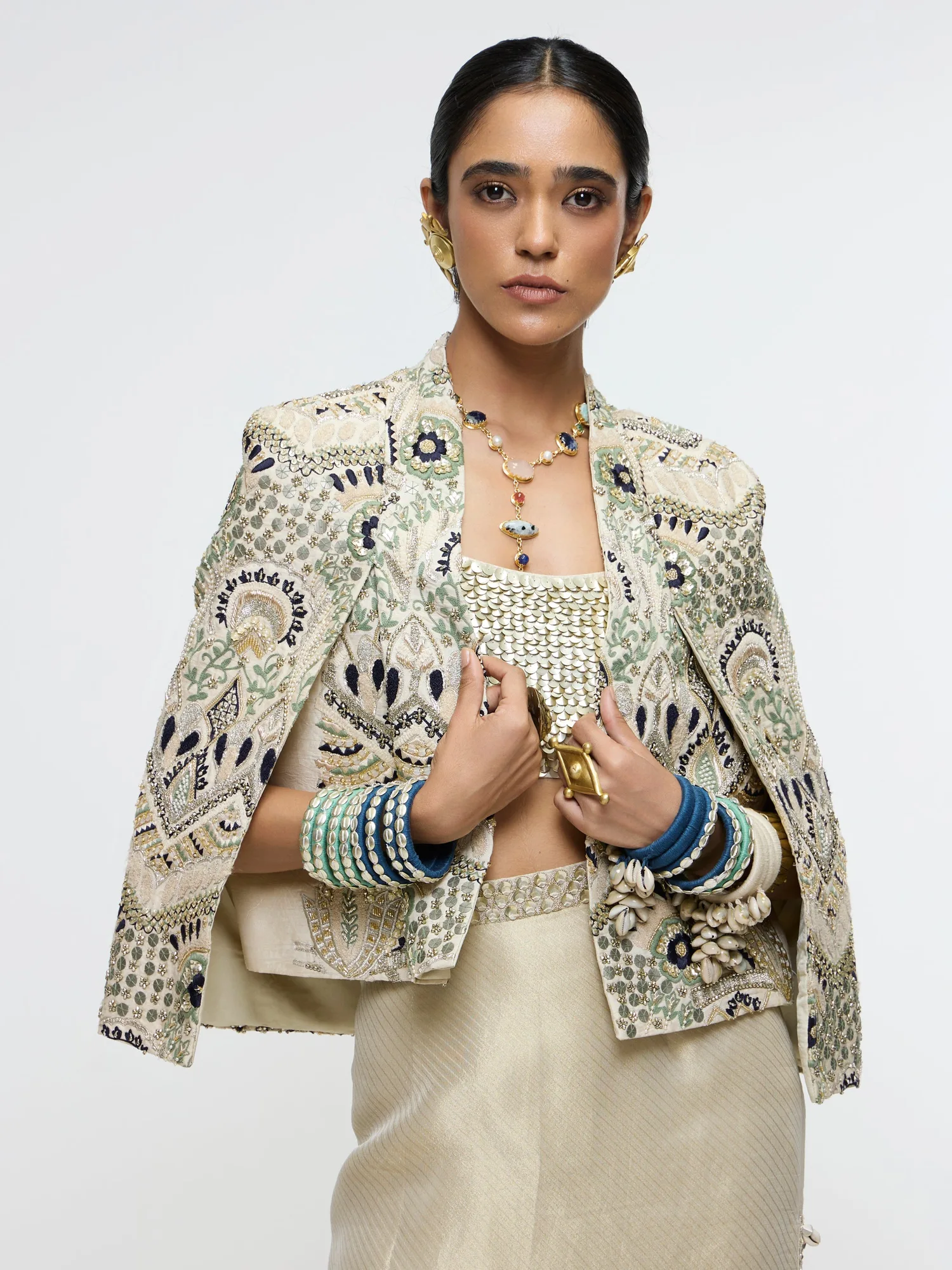Inayat Embellished Cape Jacket Paired With Metallic Scallop Bustier And Ivory Slit Skirt. by SVA, ivory jacket set, view 4