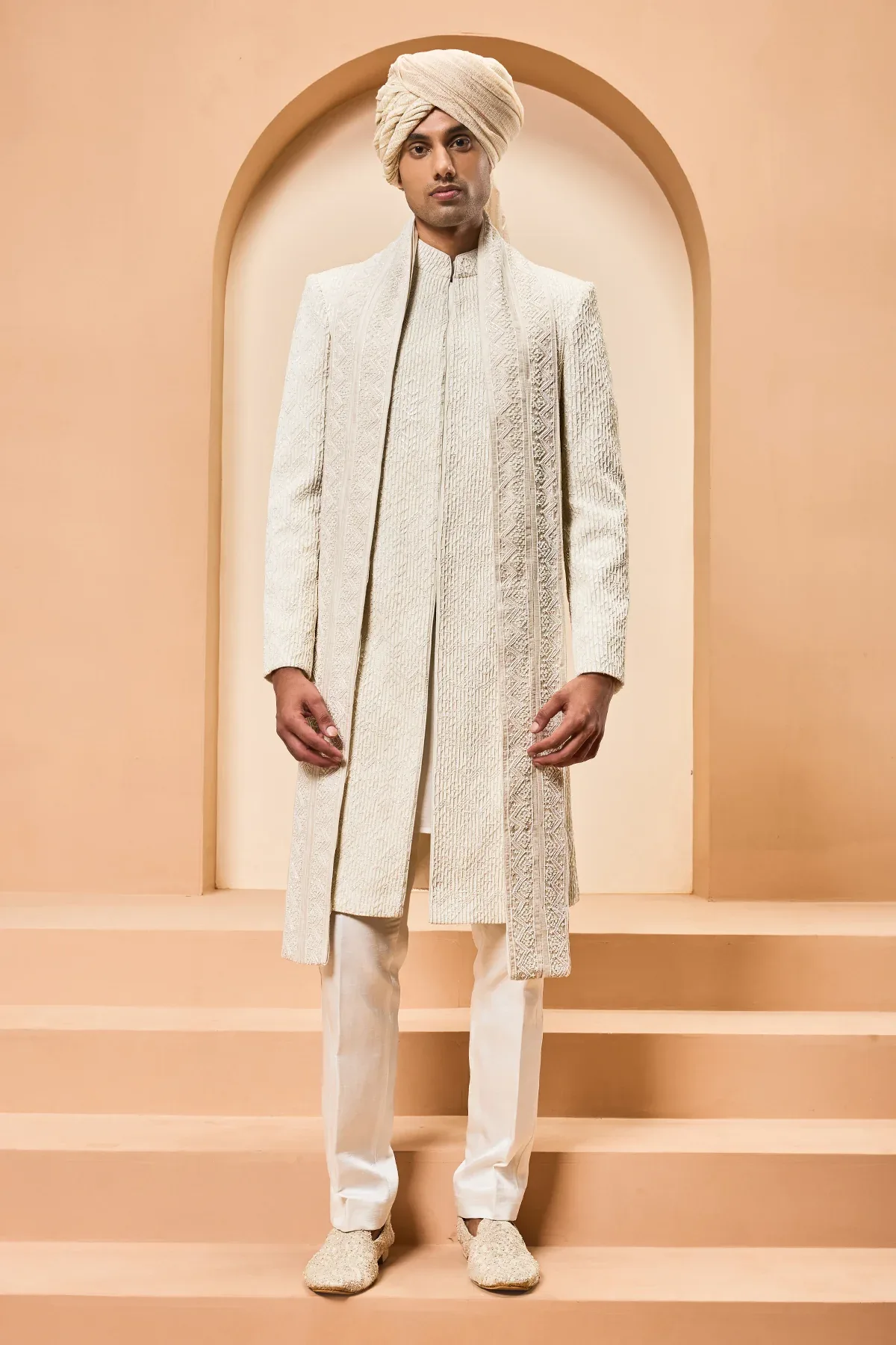 Ivory sherwani detailing with pearl sequins and thread work by Sarab Khanijou